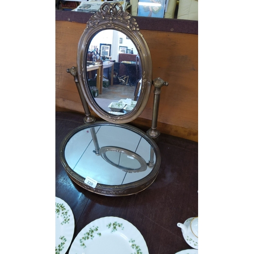 220 - Antique bronze vanity mirror with ornate detailing, featuring a swiveling oval mirror and circular m... 