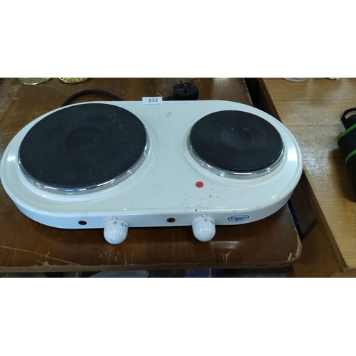 253 - Double hot plate, white in color, with two burners. Features adjustable temperature knobs and comes ... 