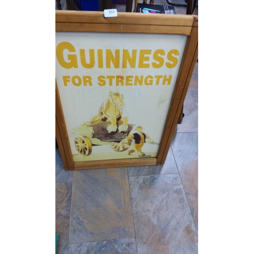 257 - Vintage Guinness advertising sign. Wood frame, depicting a worker with a horse-drawn cart. Likely mi... 