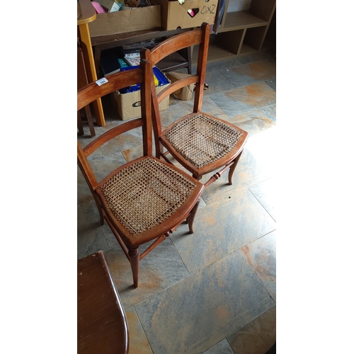 284 - Pair of French Provincial oak chairs with caned seats.