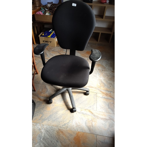 285 - Adjustable swivel office chair with black fabric upholstery. Features ergonomic backrest and armrest... 