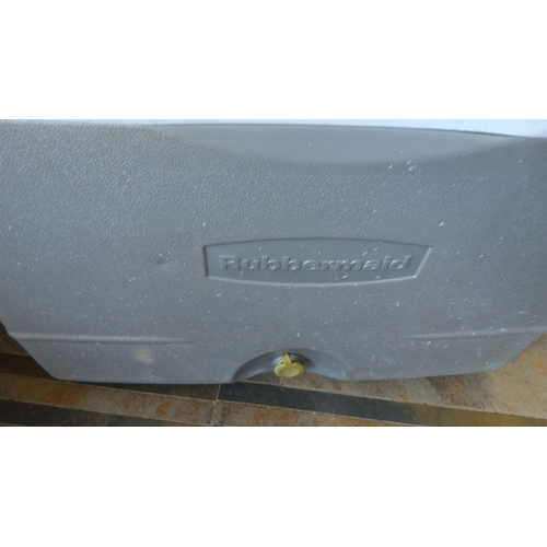 287 - Rubbermaid wheeled cooler with a pull handle and integrated cup holders.