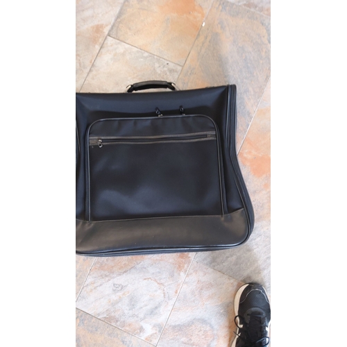 299 - Black travel garment bag, featuring a durable nylon and leather blend with zippered compartments for... 