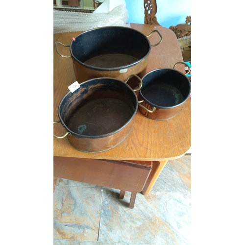 308 - Set of three vintage copper cookware pieces with brass handles. Various sizes. Classic kitchen colle... 