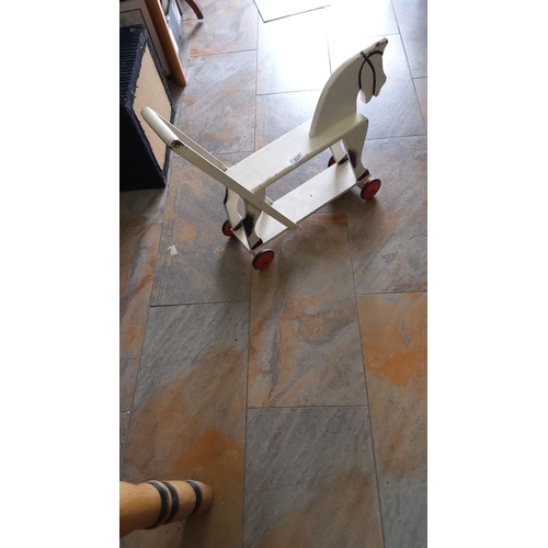 317 - Vintage wooden horse pull toy with painted detailing and red wheels. Mid-20th century design.