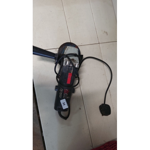 34 - 600W electric angle grinder, black with red switch, complete with side handle and power cord.