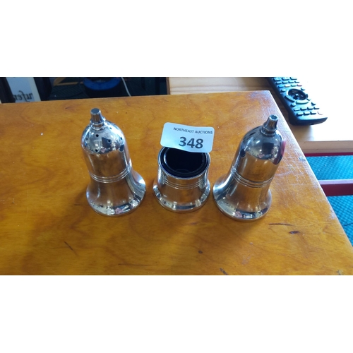 348 - Set of three polished silver plated bell-shaped salt and pepper shakers with ribbed accents.