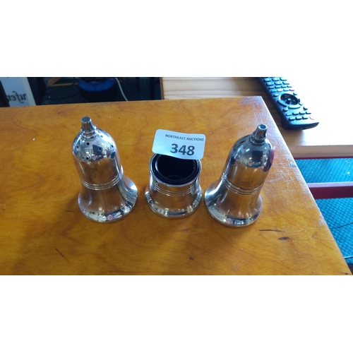 348 - Set of three polished silver plated bell-shaped salt and pepper shakers with ribbed accents.