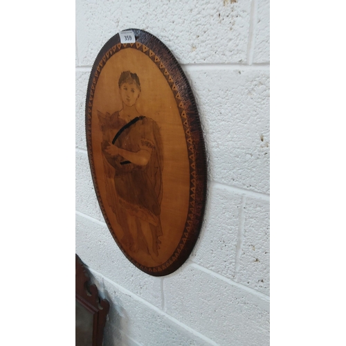 359 - Oval wooden plaque with etched art depicting a figure holding a lyre, adorned with geometric border ... 