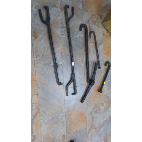 374 - Set of 7 blacksmith tongs, various shapes and sizes,cast iron construction.