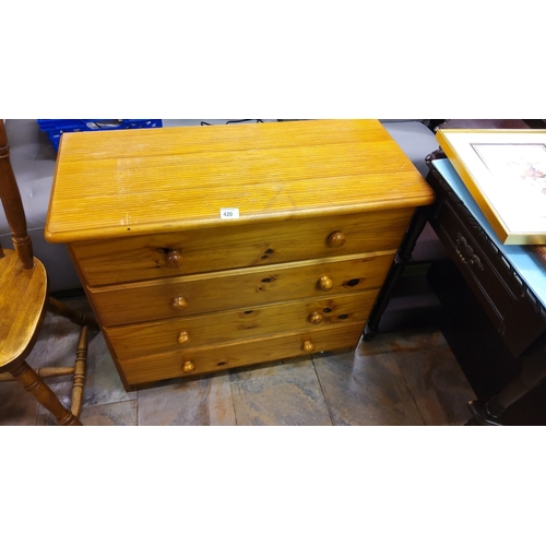 420 - Four-drawer pine chest with round wooden knobs. Sturdy construction with a natural finish.