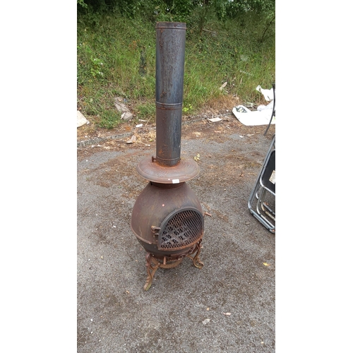 431 - Antique cast iron wood-burning stove with ornate legs and removable chimney pipe.