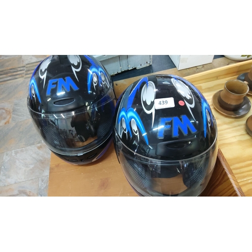 439 - Pair of FM motorcycle helmets. They have a black base with an integrated face shield.(size 60)