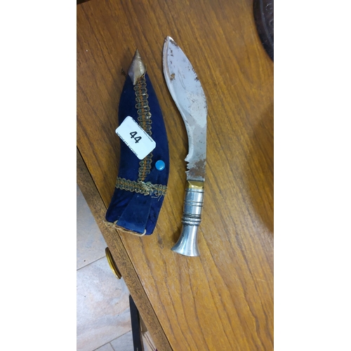 44 - Traditional Gurkha Kukri knife with curved steel blade and ornate metal handle. Accompanied by a blu... 