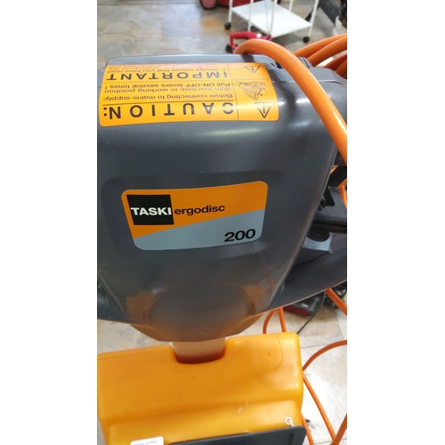 465 - TASKI ergodisc 200 floor cleaning machine with attached power cord and pad holder.