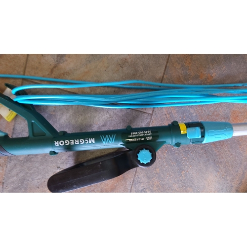 469 - Electric weed trimmer by MacGregor. Features a blue/green body with an adjustable handle. Includes a... 