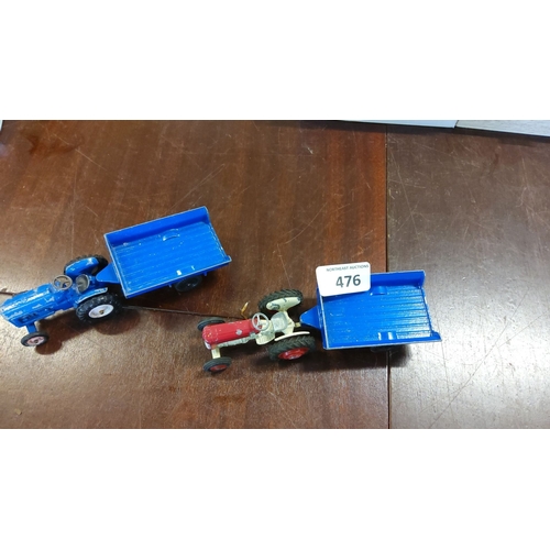 476 - Pair of vintage toy tractors with blue trailers. One in red and white, and one in blue. Miniature fa... 