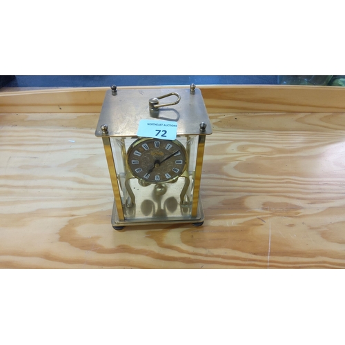 72 - Vintage brass carriage clock with Roman numerals. Features a glass case, visible movement, and top h... 