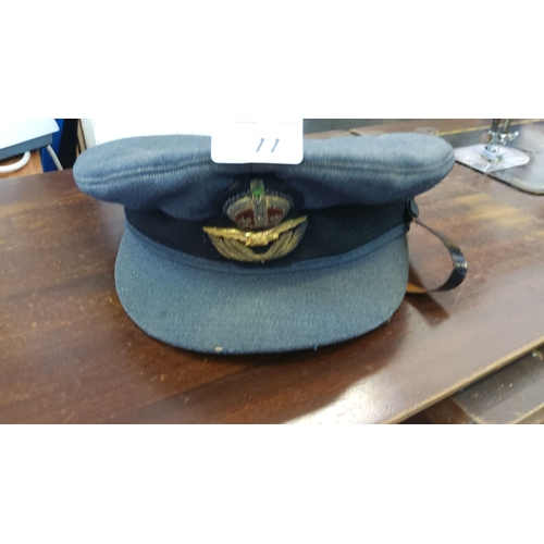 77 - Vintage blue RAF officer's peaked cap featuring embroidered insignia with crown and eagle, black lea... 