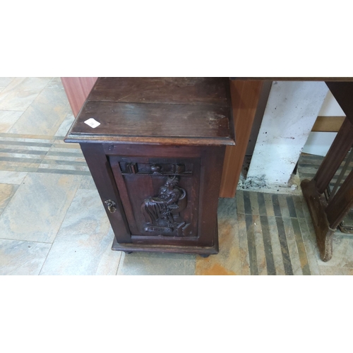 78 - Early 20th century oak cabinet with a detailed carved panel depicting a seated figure and bookshelf,... 