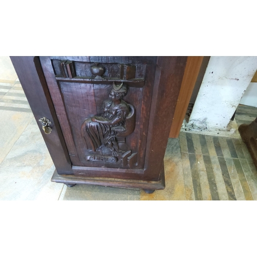 78 - Early 20th century oak cabinet with a detailed carved panel depicting a seated figure and bookshelf,... 