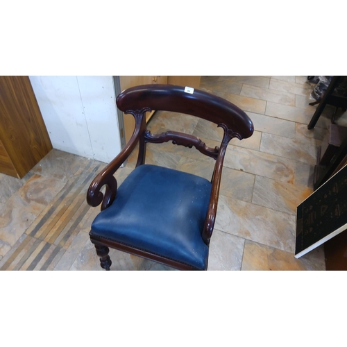 80 - Victorian-style mahogany armchair with carved backrest and scrolled arms, featuring a blue upholster... 