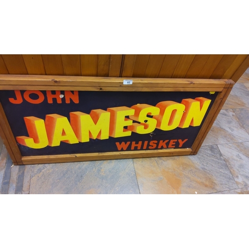 82 - Vintage Tin John Jameson Whiskey advertising framed sign. Features vibrant yellow and red text on a ... 