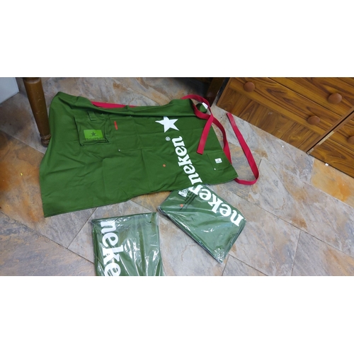 84 - Set of three green Heineken aprons with red ties. Features logo and star. Two aprons are in original... 