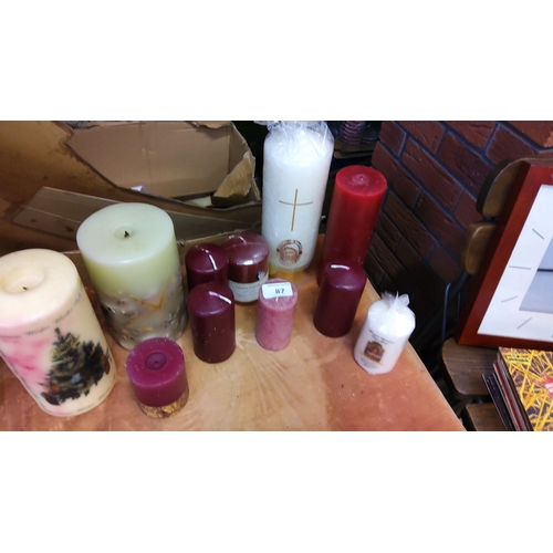 87 - Collection of assorted wax candles with various sizes, colors, and designs. Includes religious motif... 