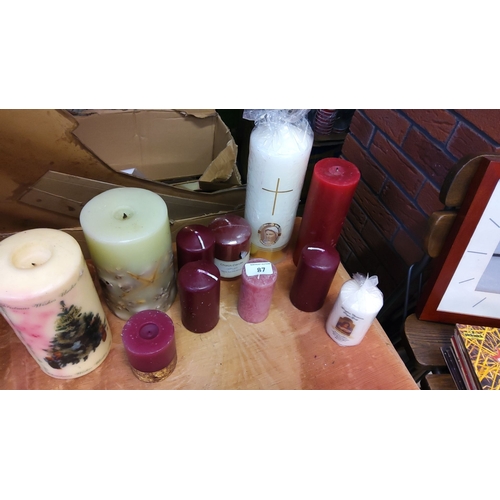87 - Collection of assorted wax candles with various sizes, colors, and designs. Includes religious motif... 
