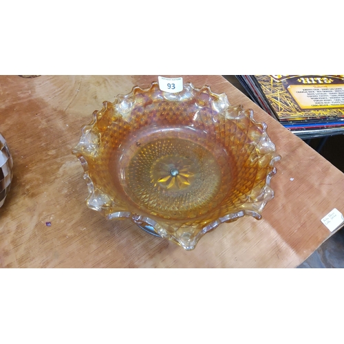 93 - Amber carnival glass bowl with ruffled edges, embossed 