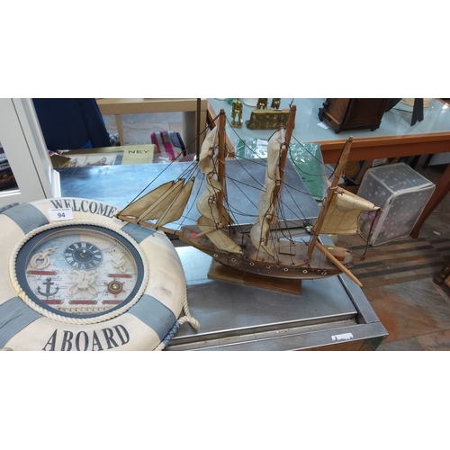 94 - Nautical decor lot consisting of a wooden sailing ship model and a nautical-themed clock housed in a... 