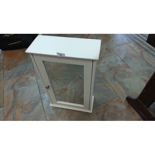 95 - White wooden wall-mounted cabinet with mirrored front and single knob door. Measures approximately 2... 