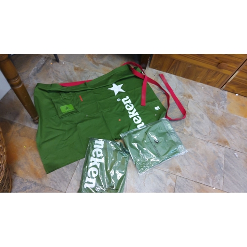 98 - Set of 3 green Heineken aprons with red straps, including two packaged aprons. These aprons are bran... 