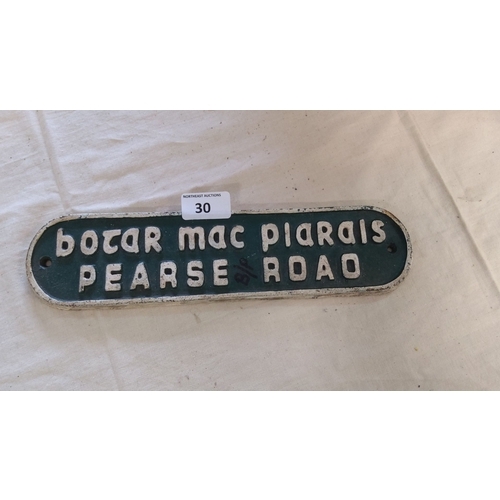 30 - Vintage Pearse Road street sign made of metal with embossed lettering. The sign has a classic green ... 