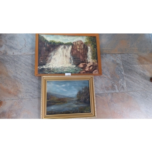 201 - Pair of framed oil on board paintings featuring landscapes. One is a serene lake scene, and the othe... 