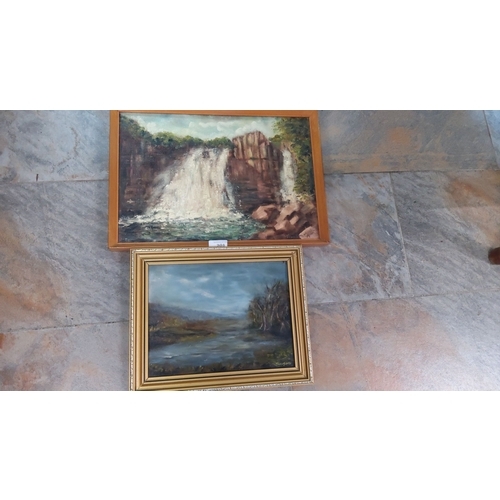 201 - Pair of framed oil on board paintings featuring landscapes. One is a serene lake scene, and the othe... 