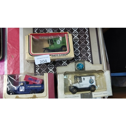 204 - Three boxed die-cast model vehicles, including promotional models by Lledo. Each model showcases vin... 