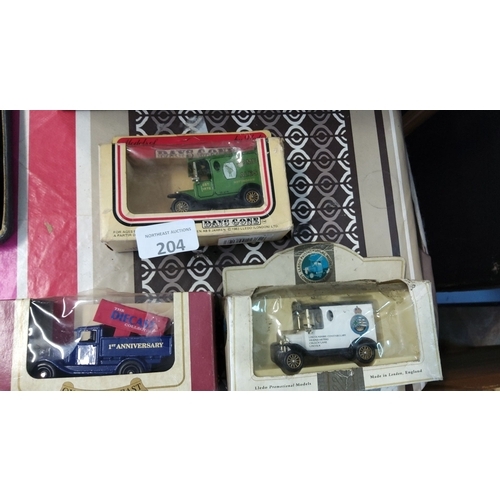 204 - Three boxed die-cast model vehicles, including promotional models by Lledo. Each model showcases vin... 