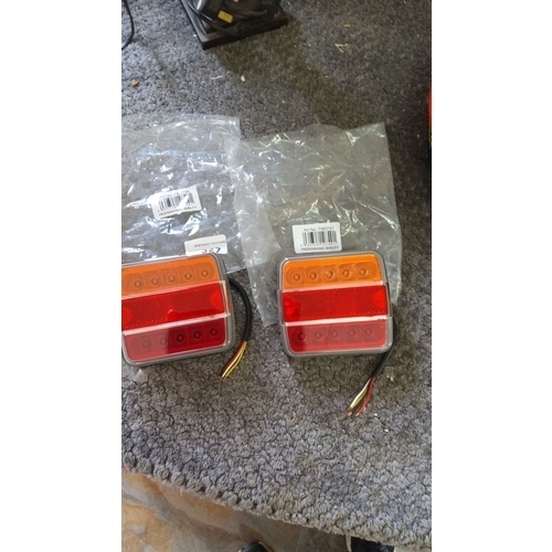 327 - Pair of automotive tail lights with red and amber LED sections. Includes wiring. Packaged with profe... 