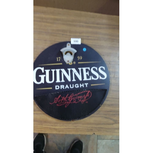 100 - Metal sign wall-mounted bottle opener, featuring iconic Guinness branding and 