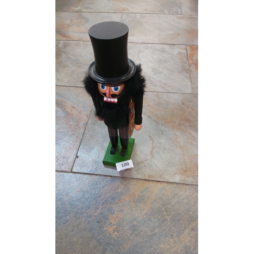 109 - Handcrafted wooden nutcracker figure dressed as a chimney sweep. Traditional design with painted det... 