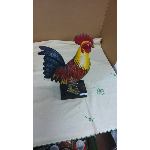 13 - Hand-painted cast iron rooster sculpture with vibrant colors.