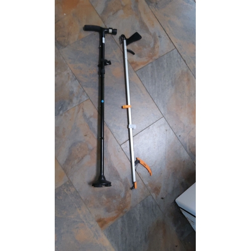 133 - Two mobility aids are available. The first one is an adjustable black walking cane that features a m... 