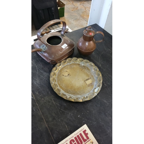 135 - Collection of vintage copperware includes a teapot, a pitcher, and an engraved brass plate.