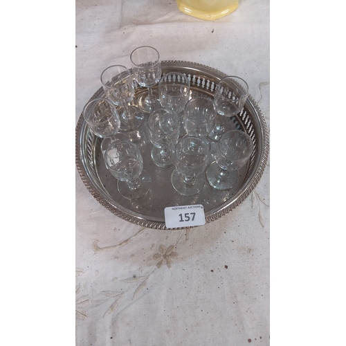 157 - Set of eight crystal wine glasses on a silver-plated serving tray with ornate pierced edges.