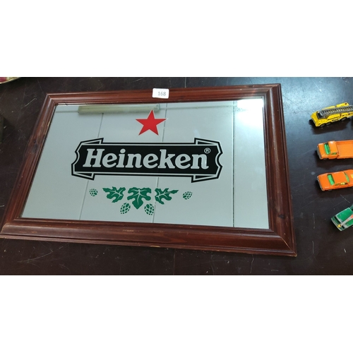 168 - Framed Heineken mirror with iconic red star and green hops logo. Dimensions approximately 22