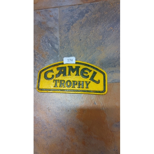 174 - Cast iron Camel Trophy sign. Yellow and green painted cast iron with embossed lettering. Measures ap... 