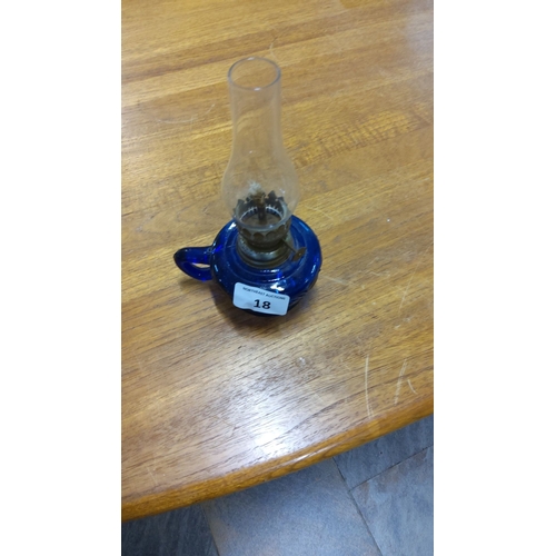 18 - Vintage blue glass oil lamp with clear glass chimney and metal burner. Stands approximately 10 inche... 