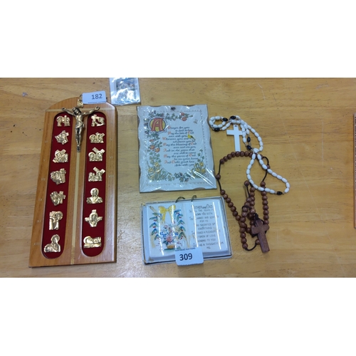 182 - Wooden crucifix with gold-tone icons, two sets of rosary beads, and three prayer plaques.